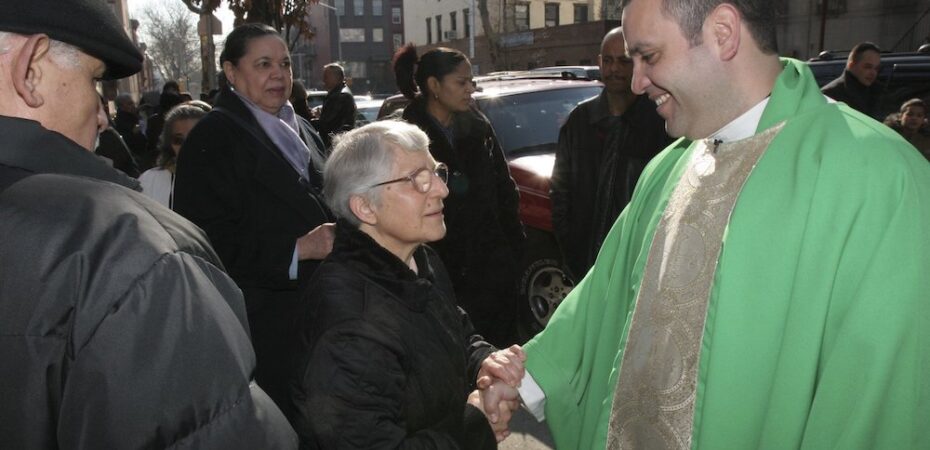Pastor greets parish staff and others